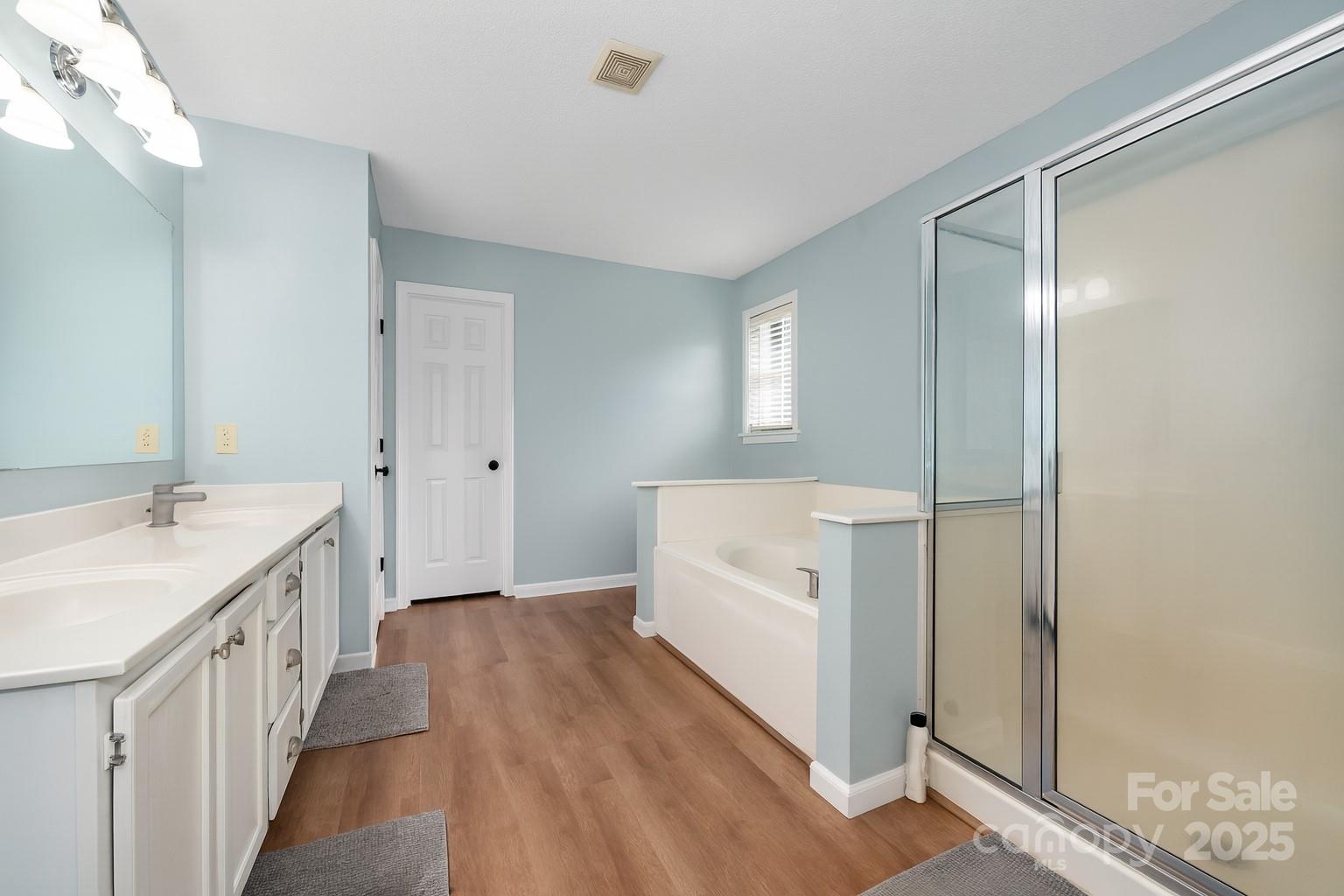 245 Castle Keep Road Salisbury, NC 28146 - Photo 17 of 26 a bathroom with a sink a mirror and a bathtub