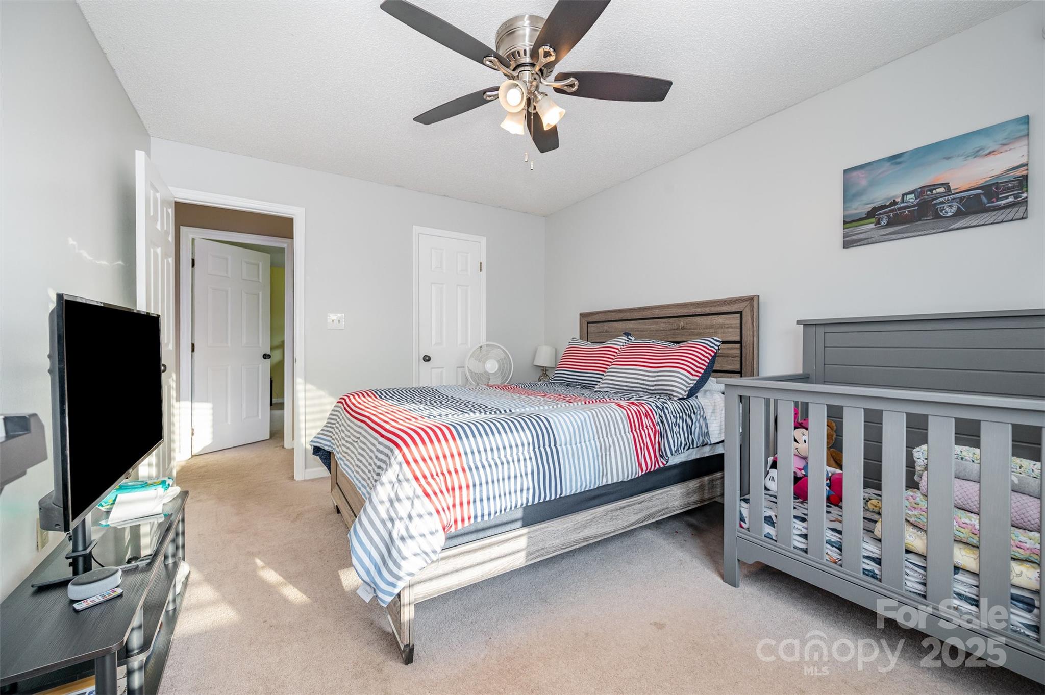 245 Castle Keep Road Salisbury, NC 28146 - Photo 19 of 26 a bedroom with bed and a flat tv screen