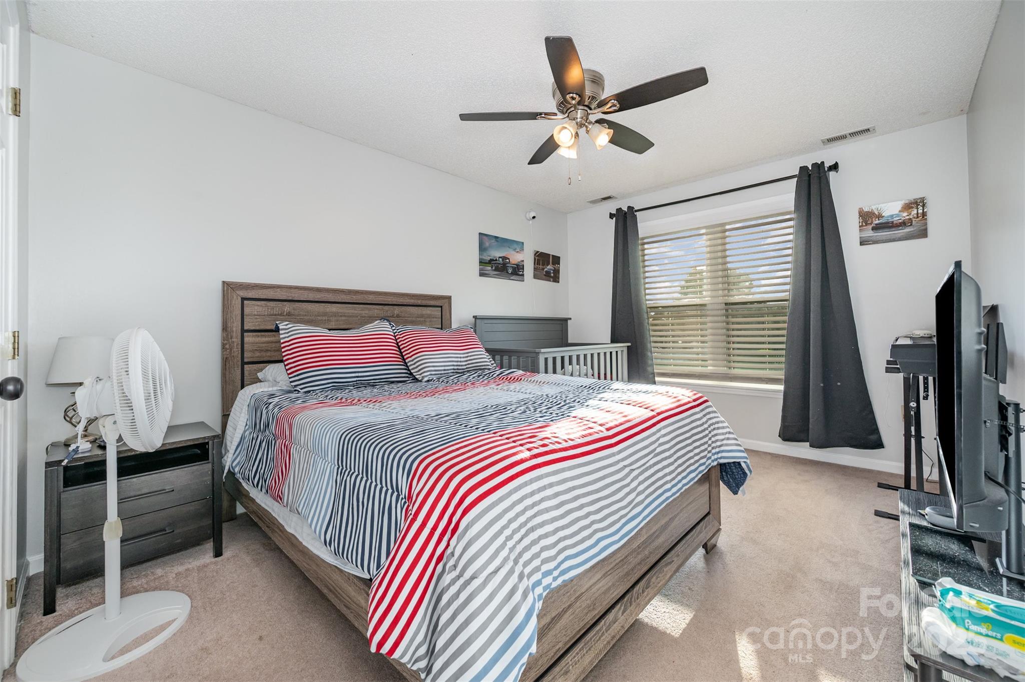 245 Castle Keep Road Salisbury, NC 28146 - Photo 20 of 26 a bedroom with a bed and a flat screen tv