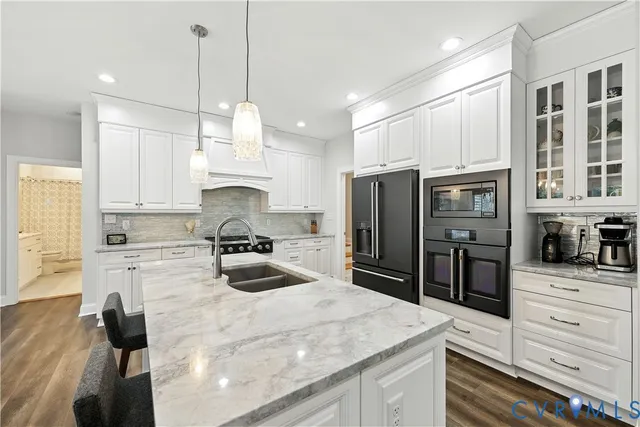 a kitchen with refrigerator a stove and a sink
