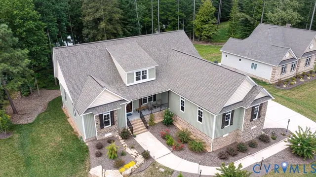 an aerial view of a house with a yard