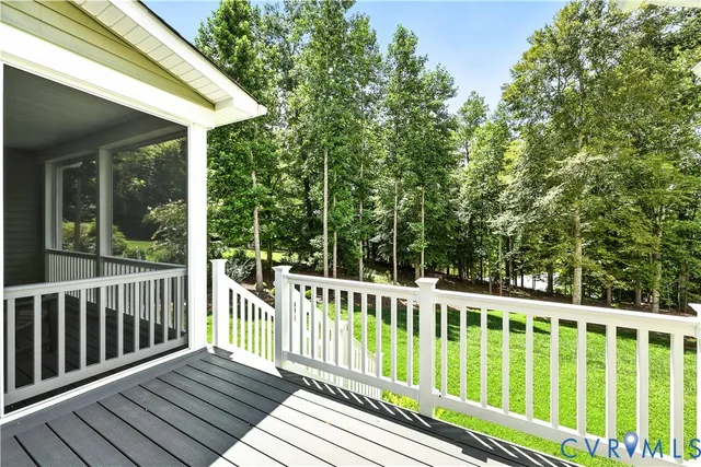 a view of a wooden deck and a yard