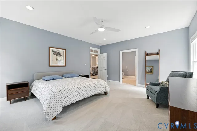 a bedroom with a bed couch and a large mirror