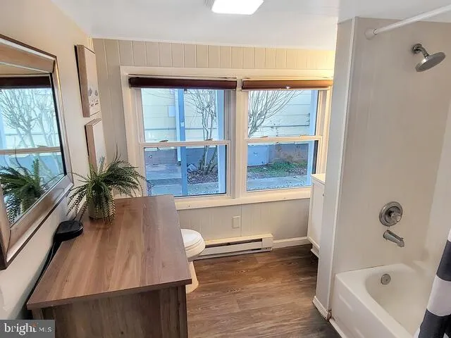 a bathroom with a bathtub and a window