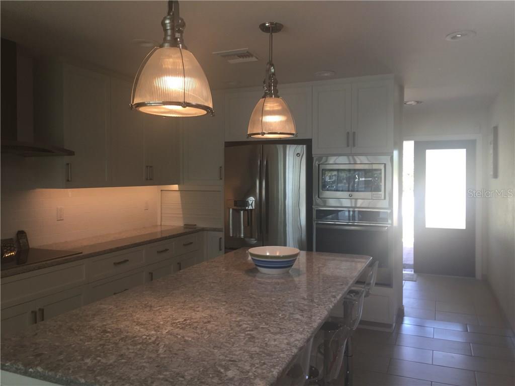 5519 Azure Way Sarasota, FL 34242 - Photo 4 of 25 a kitchen with counter top space and wooden floor