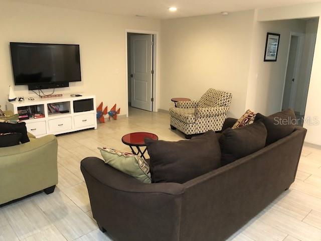 5519 Azure Way Sarasota, FL 34242 - Photo 5 of 25 a living room with furniture and a flat screen tv