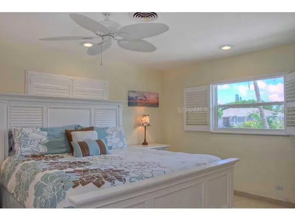 a bedroom with furniture and a large window