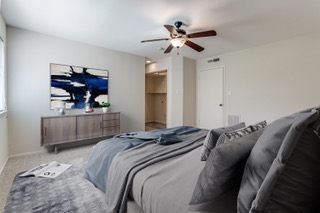 6910 Hart Lane, Unit 807 Austin, TX 78731 - Photo 11 of 36 a bedroom with a bed and a chandelier