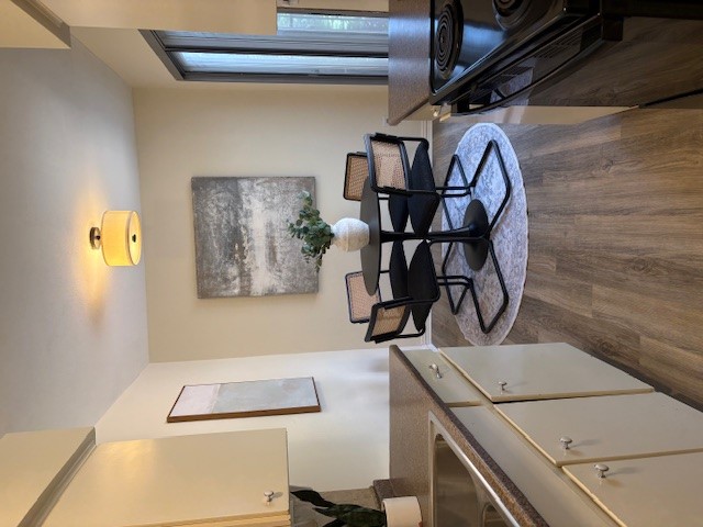 6910 Hart Lane, Unit 807 Austin, TX 78731 - Photo 23 of 36 a living room with dining table and paintings on the wall