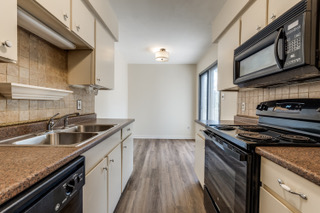 6910 Hart Lane, Unit 807 Austin, TX 78731 - Photo 5 of 36 a kitchen with stainless steel appliances granite countertop a sink stove and cabinets
