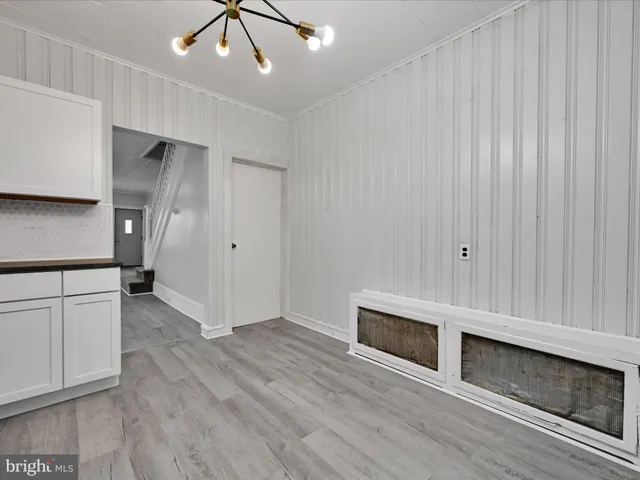 a view of a livingroom with wooden floor and a ceiling fan