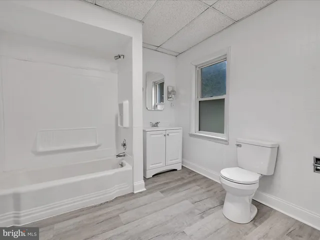 a bathroom with a toilet and a tub