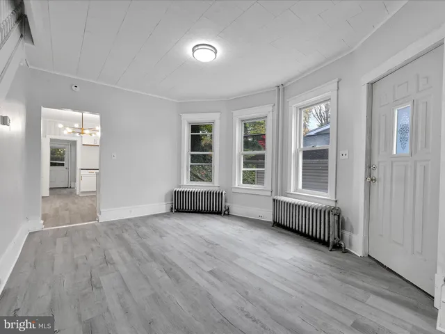 wooden floor in an empty room with a window