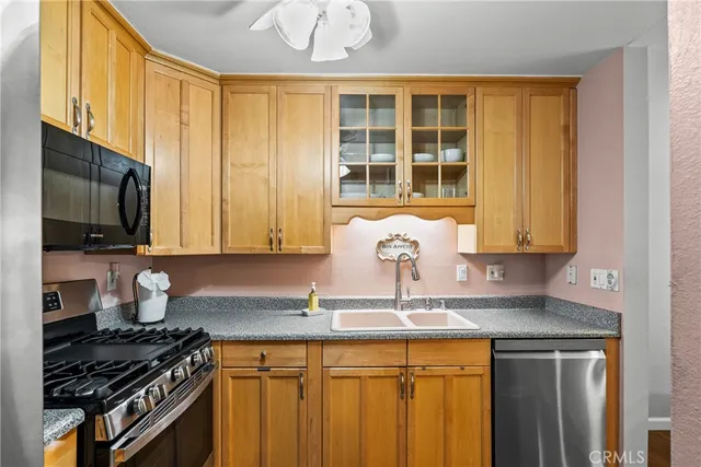 a kitchen with a sink stove and refrigerator