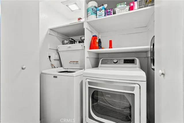 a dining room with furniture a chandelier and wooden floor