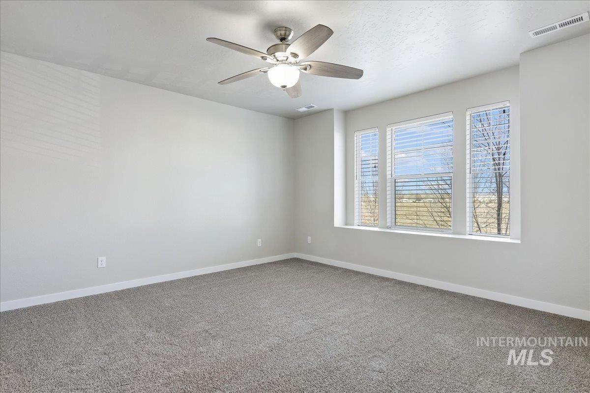 2487 East Goldstone Street Meridian, ID 83642 - Photo 10 of 25 Spare room with carpet and ceiling fan