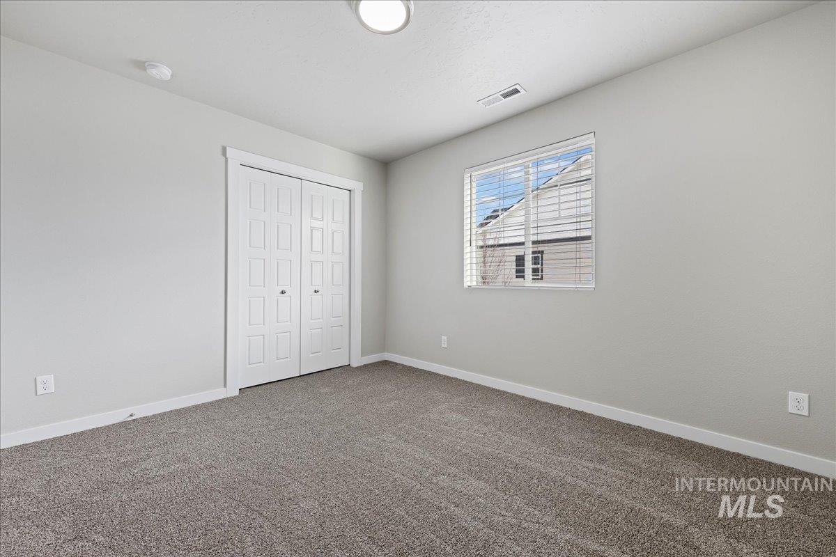 2487 East Goldstone Street Meridian, ID 83642 - Photo 12 of 25 Unfurnished bedroom with carpet and a closet