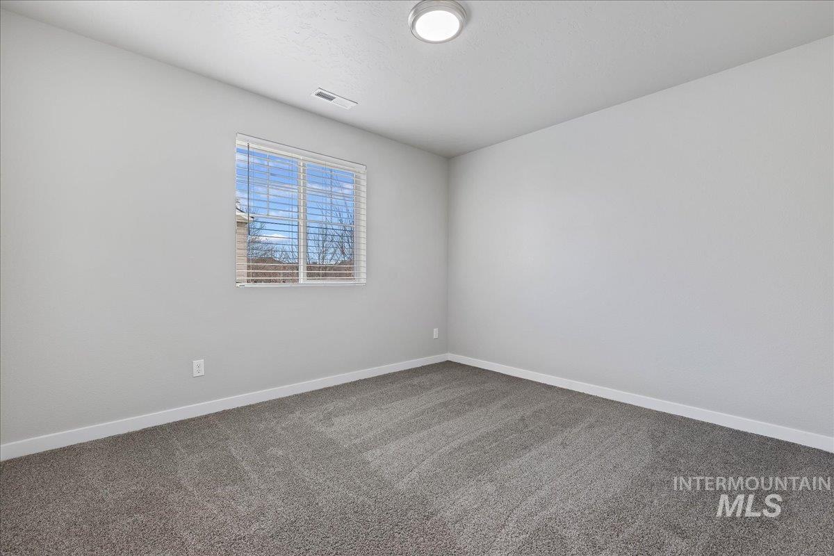 2487 East Goldstone Street Meridian, ID 83642 - Photo 13 of 25 Carpeted empty room featuring baseboards