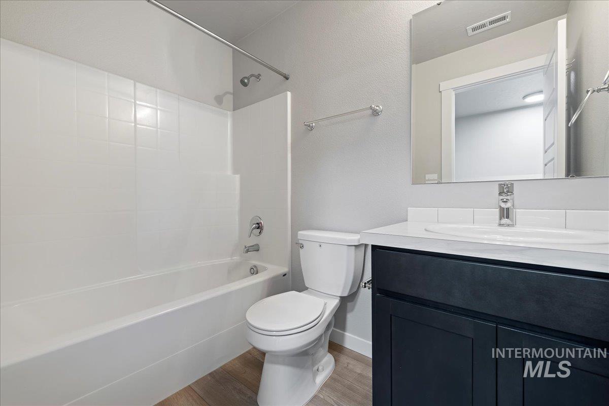 2487 East Goldstone Street Meridian, ID 83642 - Photo 14 of 25 Full bath with tub / shower combination, vanity, light wood-style flooring, and a textured wall