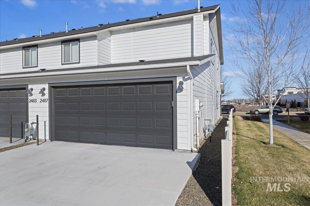 2487 East Goldstone Street Meridian, ID 83642 - Photo 21 of 25 View of side of property with driveway and a lawn