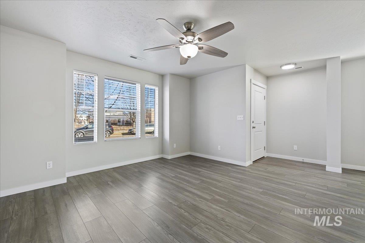 2487 East Goldstone Street Meridian, ID 83642 - Photo 5 of 25 Unfurnished room with a ceiling fan and light wood-style flooring