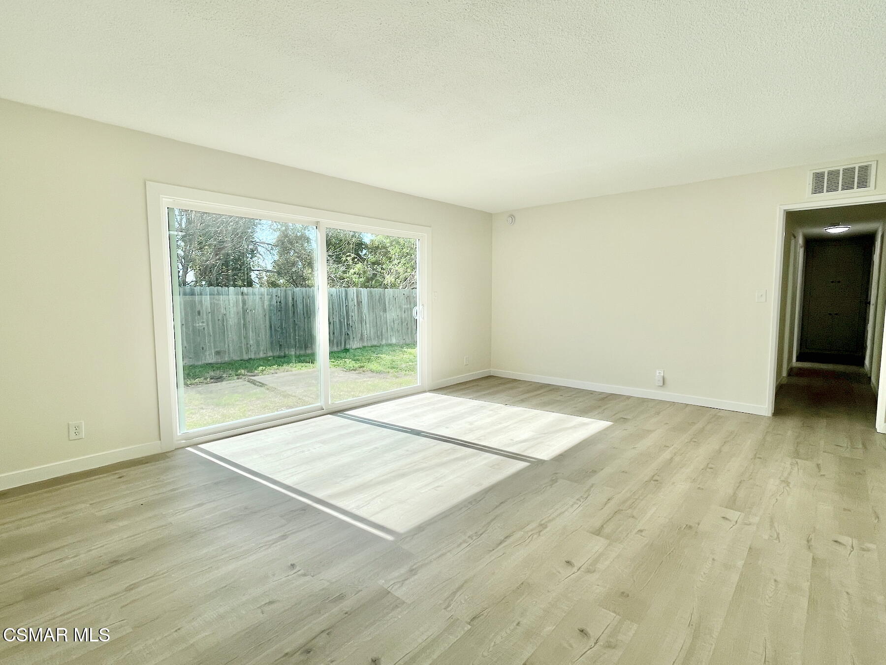 1240 Graham Street Simi Valley, CA 93065 - Photo 5 of 22 a view of an empty room with wooden floor and a window