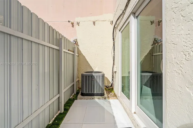 a view of a balcony with wooden floor and door