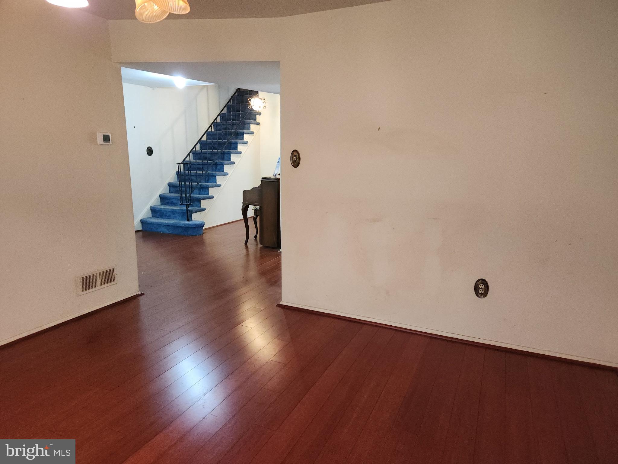 7 Ridge Road Malvern, PA 19355 - Photo 3 of 16 an empty room with wooden floor and stairs