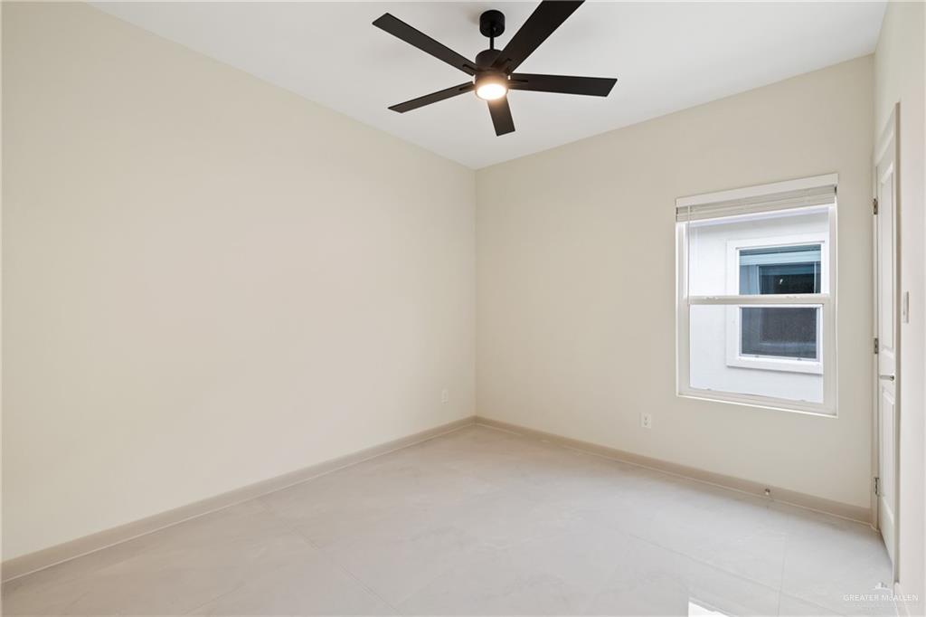 1804 West Violet Drive, Unit 3 Pharr, TX 78577 - Photo 8 of 15 an empty room with a window and a ceiling fan
