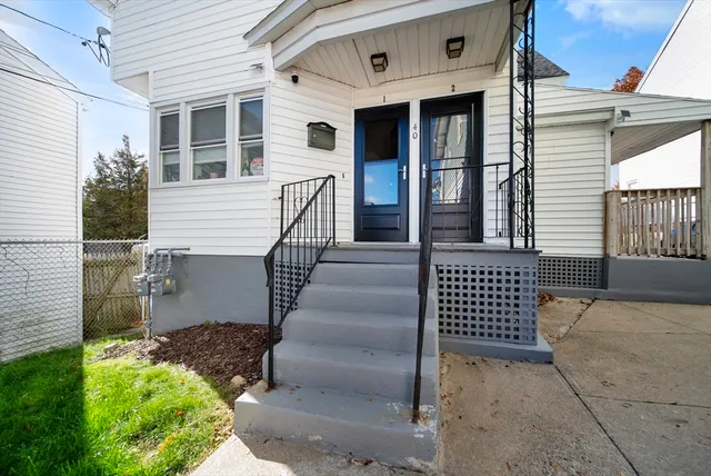 a view of a house with entryway and wooden fence