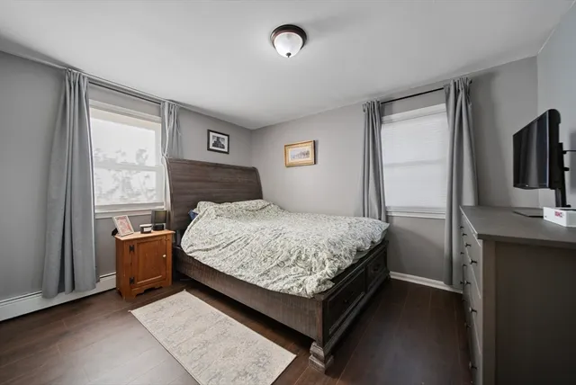 a bedroom with a bed and large window