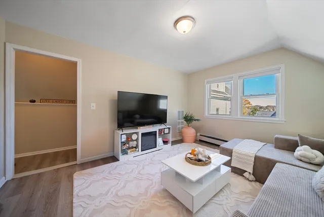 a living room with furniture chess table and a window
