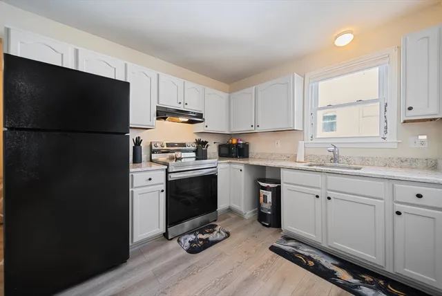 a bed room with a bed tv and a window