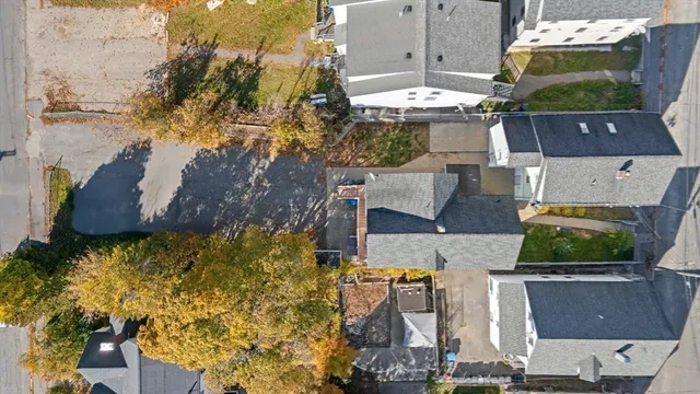 an aerial view of a house with a yard swimming pool and outdoor seating