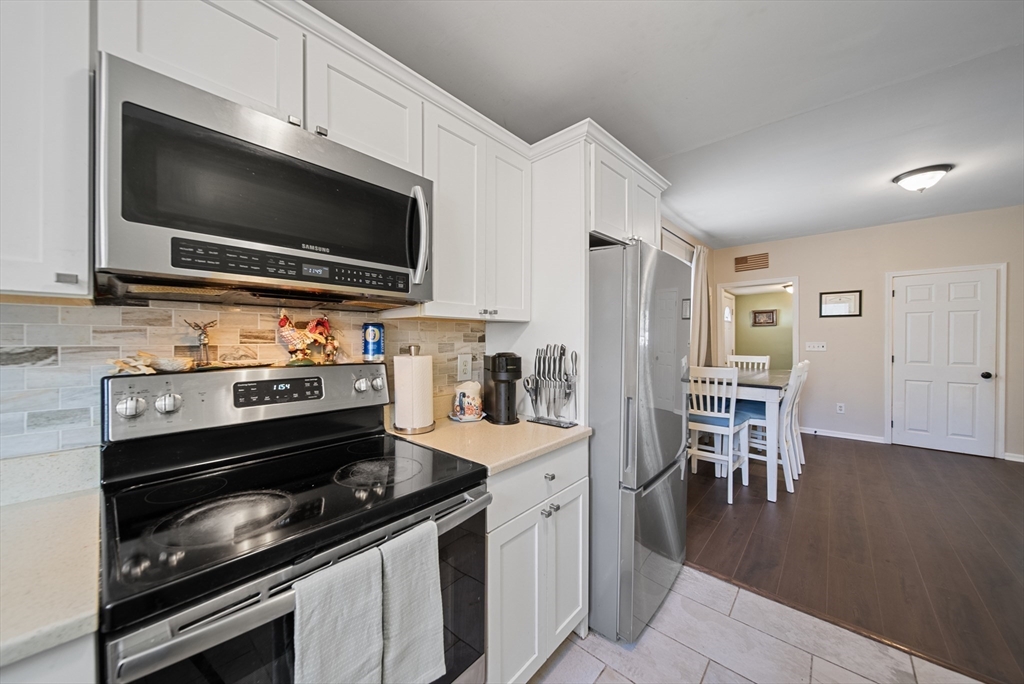 40 Bellevue Avenue Haverhill, MA 01832 - Photo 6 of 38 a kitchen with a stove and a microwave