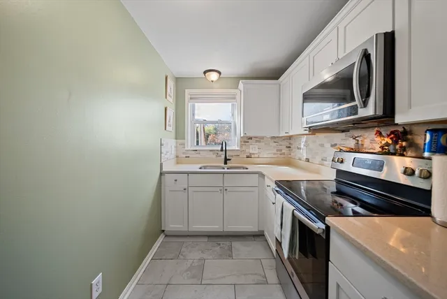 a kitchen with a sink stove and microwave