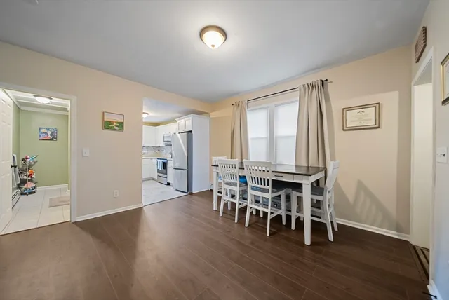 a dining room with furniture and wooden floor