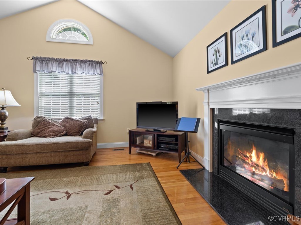 1875 Capeway Road Powhatan, VA 23139 - Photo 12 of 42 a living room with furniture a flat screen tv and a fireplace
