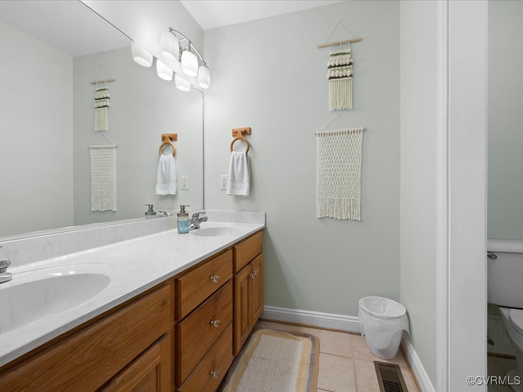 1875 Capeway Road Powhatan, VA 23139 - Photo 19 of 42 a bathroom with a sink a toilet and a large mirror