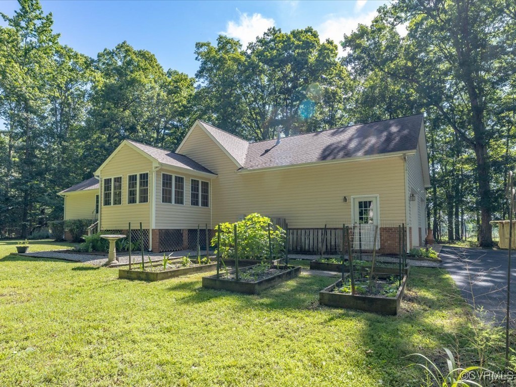 1875 Capeway Road Powhatan, VA 23139 - Photo 2 of 42 a front view of a house with a yard table and chairs