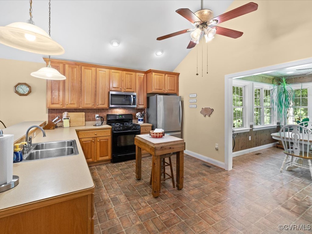 1875 Capeway Road Powhatan, VA 23139 - Photo 7 of 42 a kitchen with a refrigerator a stove top oven a sink a dining table and chairs with wooden floor