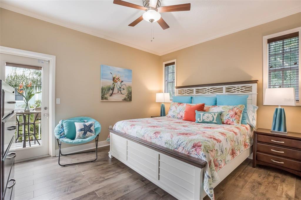 318 64th Street Holmes Beach, FL 34217 - Photo 16 of 33 a bedroom with a bed and a chandelier