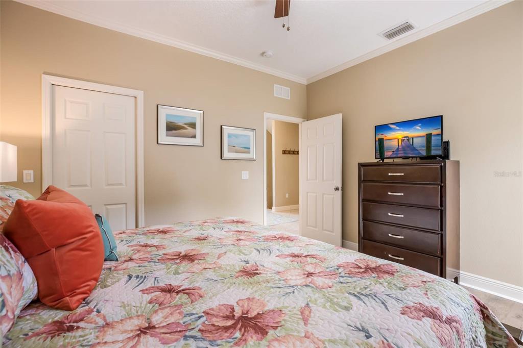 318 64th Street Holmes Beach, FL 34217 - Photo 17 of 33 a bedroom with a bed and a television