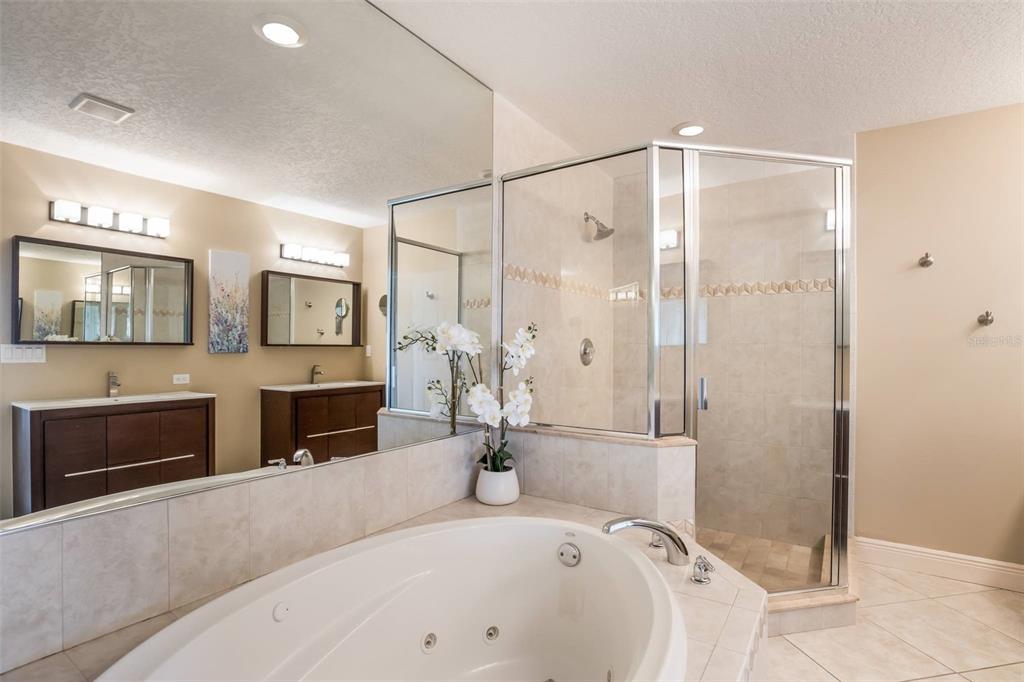 318 64th Street Holmes Beach, FL 34217 - Photo 19 of 33 a spacious bathroom with a tub sink and mirror