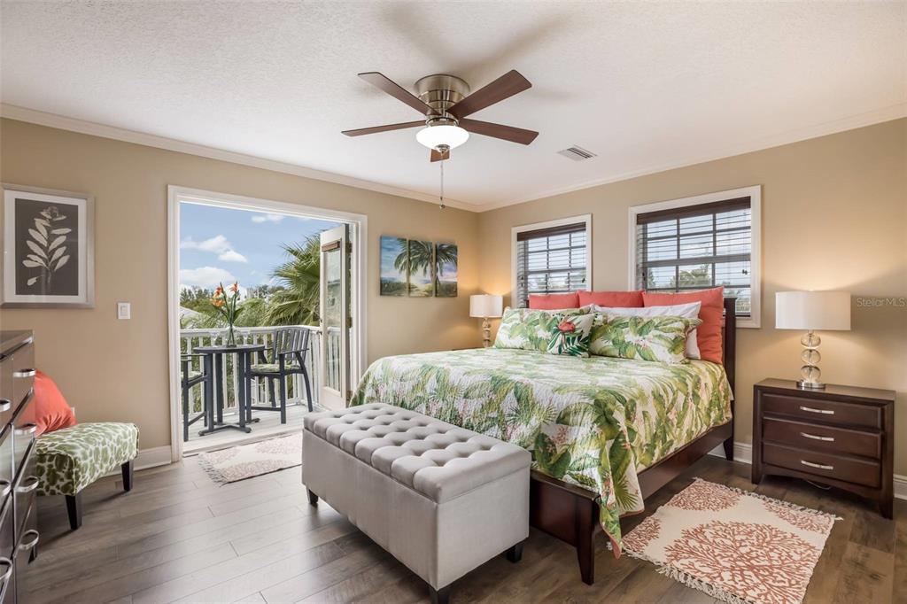 318 64th Street Holmes Beach, FL 34217 - Photo 21 of 33 a bedroom with a bed and a couch