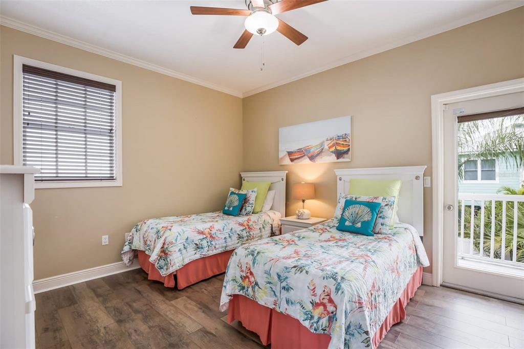 318 64th Street Holmes Beach, FL 34217 - Photo 23 of 33 a bedroom with two beds and a chandelier