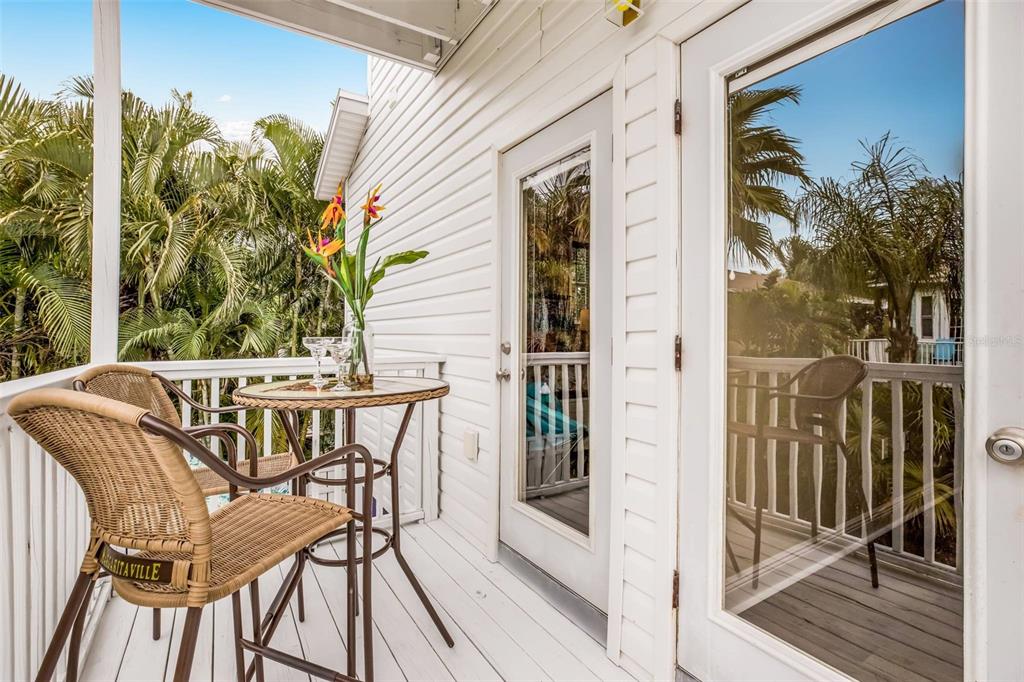 318 64th Street Holmes Beach, FL 34217 - Photo 29 of 33 a view of balcony with a potted plant and wooden floor
