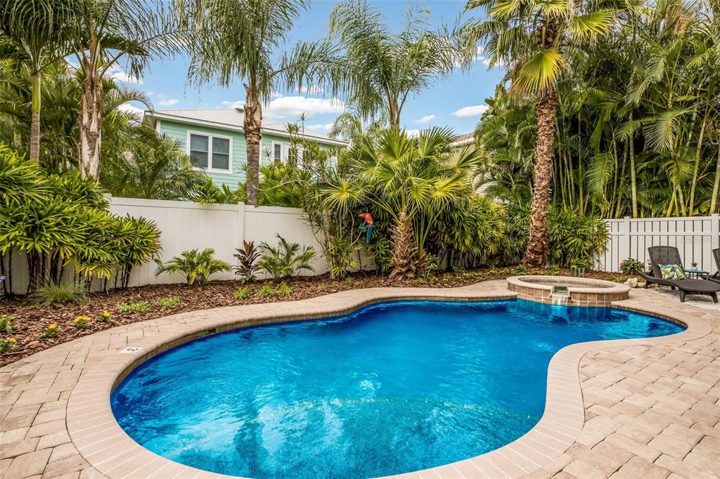 318 64th Street Holmes Beach, FL 34217 - Photo 5 of 33 a swimming pool with outdoor seating and yard