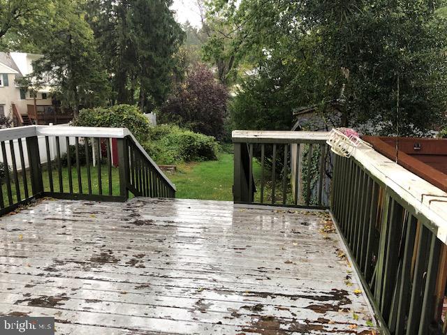 a view of backyard with deck and trees