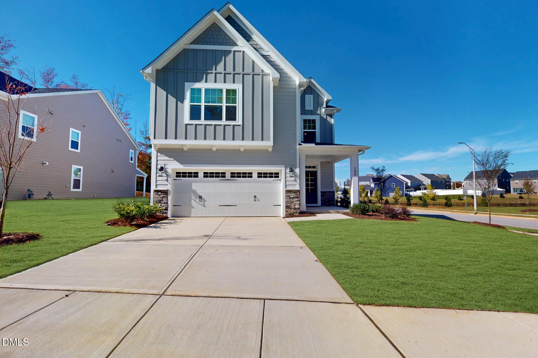 a front view of a house with a garden and yard